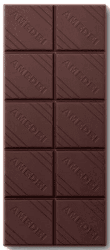 Close-up of a dark chocolate bar with the brand name 'AMEDER' embossed on each square.